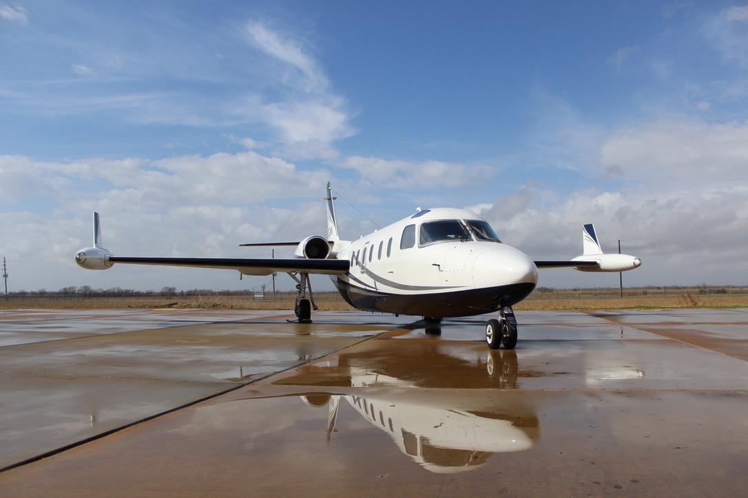 Business aircraft on the ramp outside a maintenance hangar